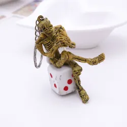 Skeleton sitting on a dice - keychainKeyrings