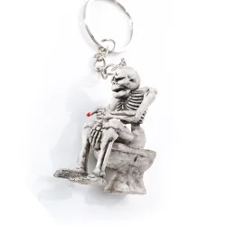 Skeleton sitting on the toilet - rubber keychainKeyrings