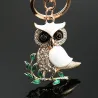 Sitting on the branch white crystal owl - keychainKeyrings